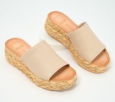 This fashionable flatform sandal pairs sleek leather with boho-chic raffia, creating a cool juxtaposition that's just as at home at the beach resort as it is in the city center. From Dolce Vita. Straw Sandals With Cork-bed Midsoles For Summer, Trendy Woven Leather Beach Sandals, Beach Straw Wedge Sandals With Cork-bed Midsoles, Trendy Natural Straw Sandals, Summer Beach Sandals With Woven Leather, Trendy Vacation Wedge Sandals With Textured Sole, Trendy Wedge Sandals With Textured Sole For Vacation, Trendy Platform Footbed Sandals For Vacation, Trendy Textured Sole Wedge Sandals For Vacation