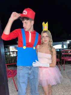 a young man and woman dressed up as mario and princess peach from mario kart