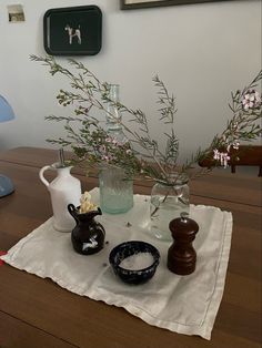 a table topped with vases filled with flowers