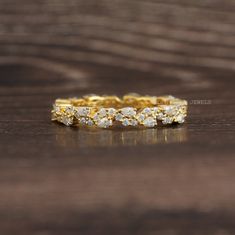 an image of a gold wedding band with diamonds on the side and in the middle