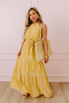 You are sure to feel nothing but happiness when you dress to impress in this beautiful primrose yellow colored maxi featuring lightweight flowy material patterned with a subtle floral print, a high neckline with a halter tie closure, ruffled trim detailing, a cinched waistline with a tie belt, and a relaxed tiered skirt silhouette that cascades into a straight ankle-length hemline! Measurements S : Bust 30", Hip 38", Length 54", Waist 26-28". M : Bust 32", Hip 40", Length 54", Waist 28-30". L : Yellow Floral Print Halter Neck Maxi Dress, Chic Yellow Maxi Dress With Tie Back, Spring Yellow Halter Dress For Beach, Yellow Tie Back Maxi Dress For Vacation, Yellow Halter Dress For Spring Beach Outing, Yellow Halter Dress For Beach Spring Season, Yellow Halter Dress For Spring Beach, Yellow Halter Dress For Spring Beach Occasion, Chic Yellow Halter Neck Maxi Dress