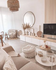 a living room filled with furniture and a flat screen tv on top of a wooden shelf