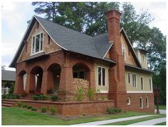 a brick house with two chimneys on the front