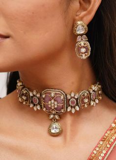 Pretty fine Victorian Kundan choker with pink/Red colored stones and Kundan and Zirconia Necklace with matching earrings The Necklace has adjustable Dori.  The Earrings Have Pushbacks  Highest quality and craftsmanship. Arrives in a box Please let me know if you have any questions Customized orders takes 3 to 4 weeks, depending on piece requirements.  The Ombre Designs Jewelry pieces can be customized in accordance with your requirement.  Please Email or Whats app on : +91 8448833193 / sonalikamehra@theombredesigns.com Sabyasachi Jewellery Earrings, Traditional Choker Jewelry For Receptions, Traditional Choker Jewelry For Reception, Ceremonial Pink Hand Set Jewelry, Ceremonial Pink Kundan Jewelry, Traditional Choker With Meenakari For Reception, Pink Temple Jewelry For Ceremonial Occasions, Bollywood Style Choker For Reception Hand Set, Reception Meenakari Choker Jewelry