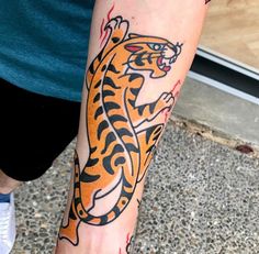 a person with a tiger tattoo on their leg