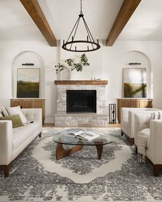 a living room filled with furniture and a fire place in the middle of a room