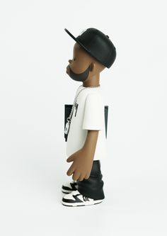 a black and white doll wearing a hat, t - shirt and sneakers with a moustache on it's face