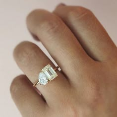 a woman's hand with a ring on it and a diamond in the middle