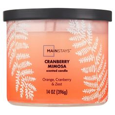 a jar of orange cranberry mimosa scented candle on a white background