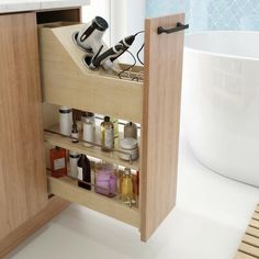 an open cabinet in a bathroom filled with personal care items