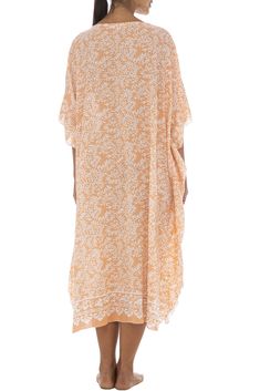 Soft as a daydream, this flowing poncho style black dress sweetens your summer downtime with its light flowing fabric and pastel buttermint hues. Handmade design features a pretty batik floral print, as well as butterfly sleeves that mirror the easy mid-calf hemline. Generously sized to provide ample coverage for womens regular to plus sizes; wear as a beach caftan, lounge dress or maxi cover up for swimwear. Back From Bali is dedicated to creating beautiful, quality clothing with a heart. All o Floral Beach Dress, Style Black Dress, Beach Caftan, Flowing Fabric, Long Beach Dress, Poncho Style, Bathing Suit Cover Up, Lounge Dress, Butterfly Sleeves