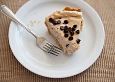 a piece of pie with chocolate chips on top and a fork sitting on a plate