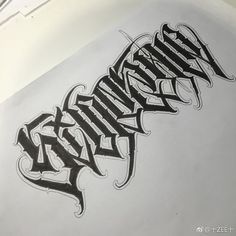 an inked piece of paper with the word tattoo on it