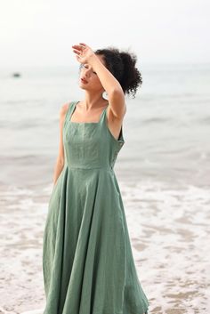 This linen square neck dress offers a timeless, elegant silhouette that's perfect for any occasion. Handcrafted in our studio to your measurements and preferences, available in over 60 colors. STYLE DETAILS - Relaxed fit - Square neckline - Sleeveless - Decorative coconut buttons on both sides - Pleated skirt - Back zipper - Seam pockets - 100 % linen, medium weight (200gsm), free-shrinkage, amazingly soft feel. - Handcrafted in our studio, French seams, clean and meticulous. DRESS LENGTH & CUSTOM - Midi length dress - Different length is possible. If the length exceeds 47'', we will charge an extra cost of $8 due to recent increases in fabric costs. Please pay for the additional length here: https://myanateliervn.etsy.com/listing/1558557893. - Custom made dress, free customizations; pleas Midi Linen Dress, Maxi Linen Dress, Linen Dresses Summer, Sleeveless Linen Dress, Custom Made Dress, Made Dress, Summer Linen Dresses, Square Neck Dress, Linen Maxi Dress