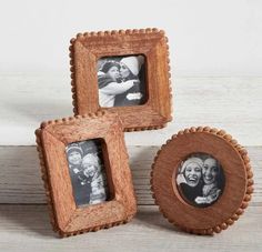 three wooden frames with two pictures in them