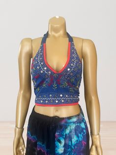 This vibrant, hand-embroidered bikini halter top offers stylish Boho-inspired fashion with its colorful threads and sequin embellishments. Paired with jeans or a skirt, this is the perfect summer top to stand out in and make a statement. The lining is a contrasting color to give it a unique, eye-catching look. One Size Made in India Care Instructions: Dry clean only Girl In The Mirror, Colorful Threads, Upcycle Design, Dazed And Confused, Design Clothes, Inspired Fashion, The Mirror, Summer Top, Perfect Summer