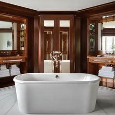 a large white bath tub sitting inside of a bathroom