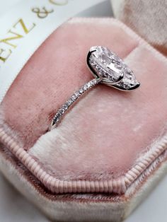 an engagement ring in a pink velvet case