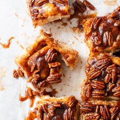 pecan pies with chocolate drizzled on top and pecans in the middle