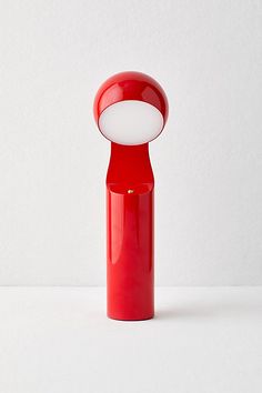 a red vase with a white light on it