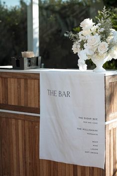 the bar is decorated with white flowers and candles