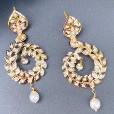 Featuring a pair of jadau earrings that are perfect for any occasion. Made in 22ct gold and embellished with finest freshwater pearls. These unique earrings feature the perfect balance of contemporary style and timeless elegance, making them the perfect gift or sentiment for any special occasion. The earrings weigh 12.04 GMs including 0.57 GMs of hanging pearl drops Elegant Kundan Pearl Drop Earrings, Elegant White Kundan Earrings, Festive Temple Jewelry Earrings With Pearl Pendant, Elegant Hand-set Pearl Earrings, White Pearl Pendant Earrings For Festive Occasions, Elegant Pearl Drop Hoop Earrings For Festive Occasions, Elegant Meenakari Bridal Earrings For Formal Occasions, Hand Set Pearl Chandbali Earrings, Festive Chandbali Earrings With Pearl Pendant