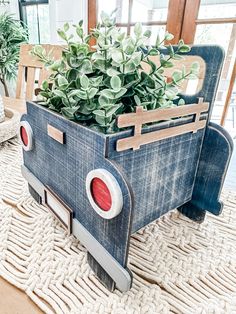 a planter made out of an old car is sitting on a rug in the living room