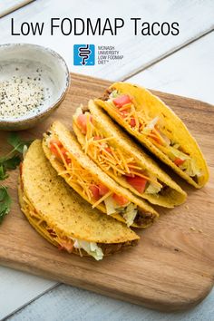 there are four tacos on the cutting board