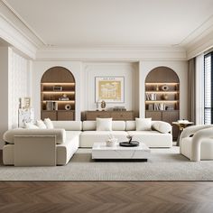 an elegant living room with white furniture and wood flooring, along with built in bookshelves