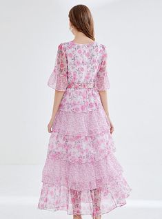 "Bathed in the soft blush of cherry blossoms, this enchanting tiered dress is a hymn to springtime romance. The delicate floral print weaves a narrative of blooming gardens and whispered tales of first love. Its graceful round neckline and sheer, breezy half-sleeves suggest an air of both demure charm and understated elegance. Cinched at the waist with an ornate rose buckle belt, the dress cascades down in ruffled layers, creating an ethereal sway with every step. This dress doesn't just capture Elegant Brunch, Printing Skirt, Leaf Cake, Chiffon Floral Dress, Springtime Wedding, Cake Skirt, Sleeveless Dresses Casual, Floral Chiffon Dress, Chiffon Floral