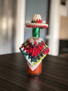 a jar filled with ketchup sitting on top of a wooden table