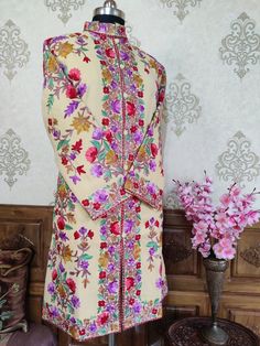 Kashmiri Jacket Women, Embroidery Jacket, Kashmiri Coat Get Customizable Kashmiri Jacket With Multi-colour Embroidery  A Long Woolen Kashmiri Jacket with All Over Multicolour Aari Embroidery (Front & Back) This Kashmiri jacket Makes you stand apart with its vivid colours and Floral embroidery, The base colour is Beige With  Multicolor Aari Embroidery is done all over the jacket, the material used is of high-quality Pure wool and the embroidery is done by brilliant Kashmiri artisans. Embroidery Designer Multicolor Bandhgala With Chikankari Embroidery, Festive Multicolor Bandhgala With Chikankari Embroidery, Designer Multicolor Nehru Jacket With Zari Work, Cream Bandhgala With Intricate Embroidery Long Sleeve, Beige Long Sleeve Sherwani With Intricate Embroidery, Beige Long Sleeve Sherwani With Resham Embroidery, Beige Long Sleeve Bandhgala With Intricate Embroidery, Designer Traditional Wear With Resham Embroidery And Stand Collar, Bollywood Style Outerwear With Chikankari Embroidery For Wedding