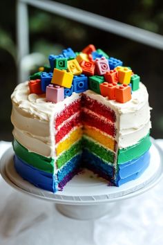 a multi - colored cake with legos on top