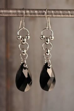 "Stainless steel dangle earrings with jet black, Austrian crystal by Swarovski. Sturdy for everyday wear, but elegant as they shine and swing with every movement. Approximately 2\" long and .5\" inches wide." Elegant Black Long Drop Jewelry, Elegant Sterling Silver Jewelry In Gunmetal, Black Hypoallergenic Earrings For Party, Black Stainless Steel Jewelry For Jewelry Making, Black Nickel-free Stainless Steel Earrings, Black Hypoallergenic Jewelry For Party, Modern Black Hypoallergenic Jewelry, Elegant Black Stainless Steel Jewelry, Evening Black Bead Drop Earrings