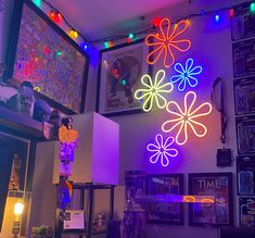 a room filled with neon lights and pictures on the wall