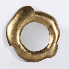 a gold colored metal object on a white background