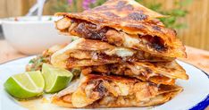 three quesadillas stacked on top of each other with a lime wedge next to them