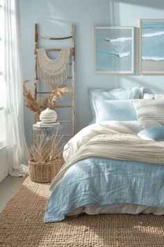 a bedroom with blue and white bedding, wicker baskets and pictures on the wall