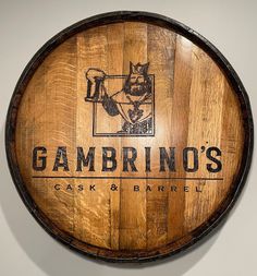 a wooden barrel with the name gambino's on it and a cat