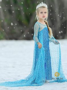 This Elsa-inspired dress for girls is a magnificent gown befitting the Frozen queen! This ice-blue creation with long, sheer sleeves shines and shimmers just like the magic of winter. Perfect for Halloween, parades, pageants, parties, pretend play, and trick-or-treating. In sizes 3T-10Y. Shop Mia Belle Girls Halloween Popular Girls Halloween Costumes, Train Costume, Elsa Hair, Frozen Queen, Sparkle Flats, Elsa From Frozen, Ice Palace, Elsa Costume, Frozen Costume