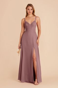 a bridesmaid in a long purple dress with thigh high slits and spaghetti straps