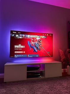 a flat screen tv sitting on top of a white entertainment center in a living room