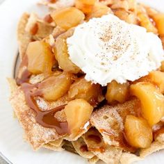 a white plate topped with waffles covered in caramel sauce and whipped cream