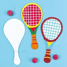 two tennis racquets and a ball on a blue background with some string