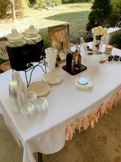 a white table topped with plates and drinks