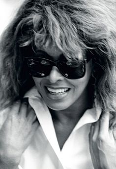 a black and white photo of a woman wearing sunglasses