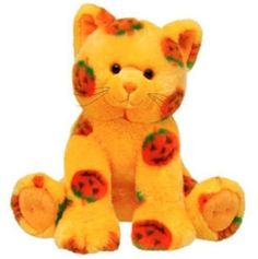 a yellow stuffed cat with orange spots on it's face and paws, sitting in front of a white background