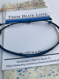 POLICE WIFE BRACELETS -  PURA-VIDE STYLE STRING BRACELET  Need an inexpensive gift for your favorite Police Officer or LEO family member? A BLUE LINE STRING BRACELET IS THE PERECT GIFT. Red line finished examples are shown until I take photos of Blue Line. **String Bracelets are ONE SIZE FITS MOST - If you need XS or XL let me know in notes. PRODUCT DESCRIPTION/MATERIALS Waxed-Polyester Adjustable String Bracelet CARE INSTRUCTIONS **Waterproof > Ok to wear 24-7 **Remove bracelet if working in ya Blue Resizable Friendship Bracelets, Minimalist Blue Friendship Bracelets For Beach, Resizable Blue Jewelry For Friendship, Blue Resizable Jewelry For Friendship, Personalized Blue Friendship Bracelets For Best Friend, Personalized Blue Braided Friendship Bracelets, Adjustable Blue Bracelet For Best Friend Gift, Adjustable Blue Wristband Gift, Blue Adjustable Wristband As Gift