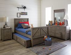 a child's bedroom with a bed, dresser and toy chest in the corner