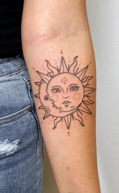 a woman with a sun tattoo on her arm